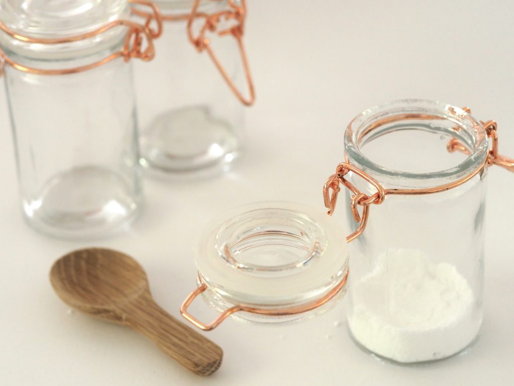 glass kitchen storage jars with a wooden spoon
